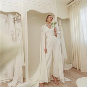 Handmade white jumpsuit with cape, a belt and the designer garment’s bag